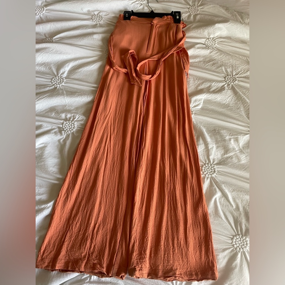Orange bellbottom linen pants with bow on front